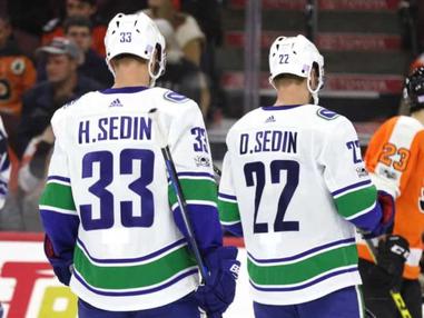 One of the Vancouver Canucks Sedin twins gives his signed jersey