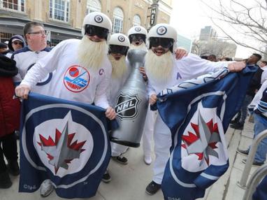 Winnipeggers attend the White Out Street Party for Winnipeg Jets game two  NHL playoff action against the Minnesota Wild in Winnipeg on Friday, April  13, 2018. THE CANADIAN PRESS/John Woods Stock Photo 