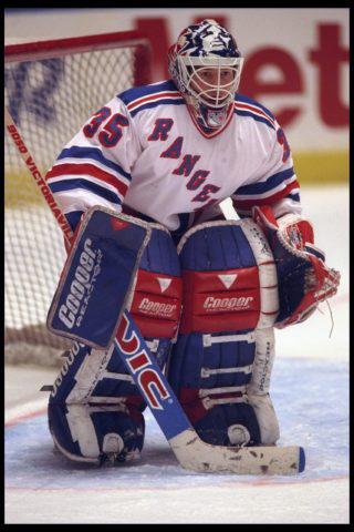 New York Rangers goalie Mike Richter tries to get out from under