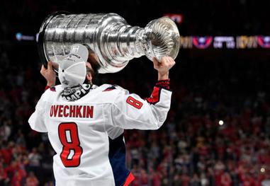 Alex Ovechkin receives mini trophies for winning Stanley Cup and being  named playoff MVP
