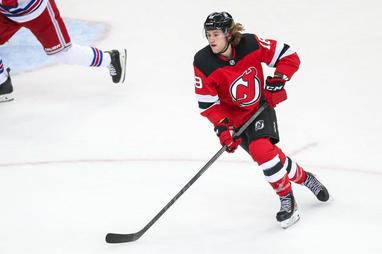 Dawson Mercer of the New Jersey Devils stands for the national